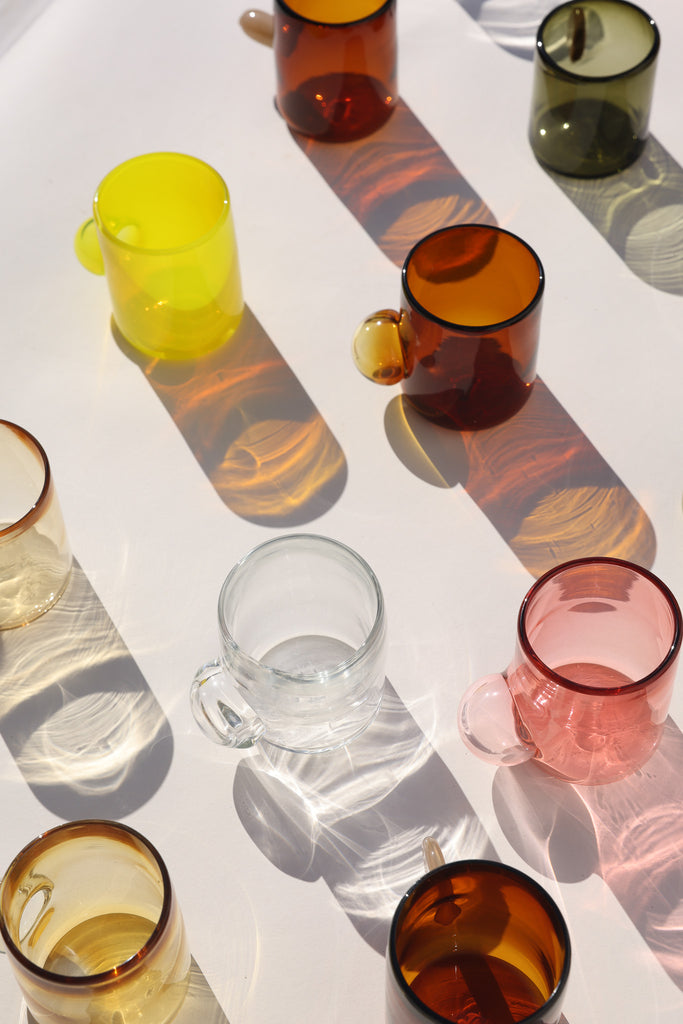 Different coloured unique hand blown artisanal glasses with reflections