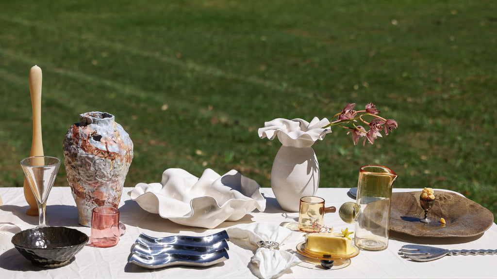 Curated table with vases, candles and artisanal products laid